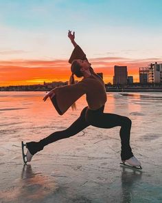 a woman is dancing on an ice rink at sunset