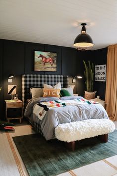 a bed room with a neatly made bed next to a green rug and potted plants