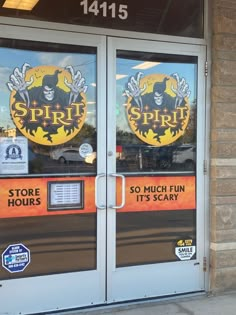 the front door of a store with signs on it's glass doors that say spirit