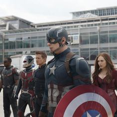 captain america the winter soldier is standing in front of other people