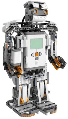 a white and orange robot is standing up