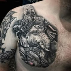 an elephant tattoo on the chest of a man