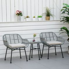 two chairs sitting next to each other on a patio