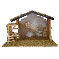 a nativity scene with sheep in the manger, hay and straw on the ground