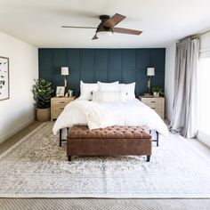 a bedroom with a large bed and a ceiling fan