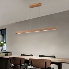 a dining room table with four chairs and a potted plant hanging from the ceiling