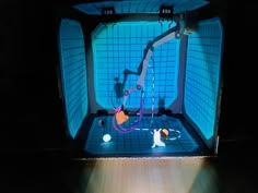 an image of a robot in the middle of a room with blue tiles on it