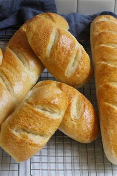 four loaves of bread on a cooling rack