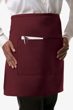 a person wearing a red apron with a pocket on the side that has a white button in it