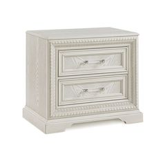 a white nightstand with two drawers on it