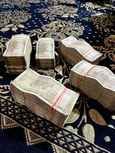 four stacks of money sitting on top of a rug