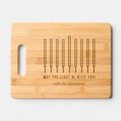 a cutting board with the words may the light be with you