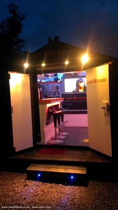 an outdoor bar is lit up at night