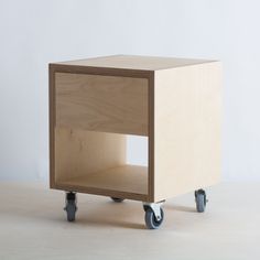 a small wooden box on wheels is shown