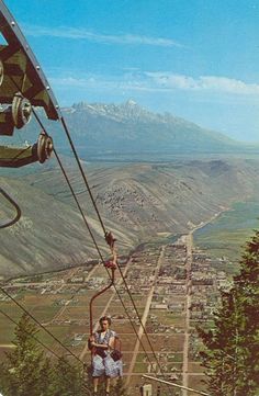 two people walking up the side of a mountain