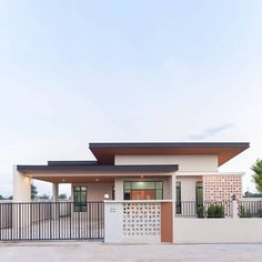 a small house with a fence around it and a gated in area next to it