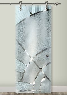 a window curtain with an abstract design on the glass and metal bars attached to it