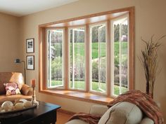 a living room filled with furniture and large windows