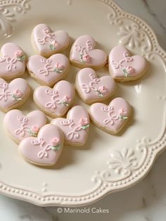 pink heart shaped cookies on a white plate