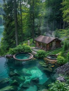 an outdoor hot tub in the middle of a lake surrounded by green trees and rocks