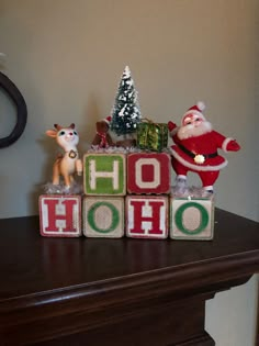 a wooden block that says ho hoo with santa claus and other christmas decorations on it