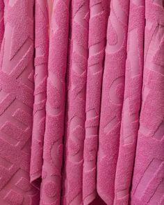 pink towels are stacked on top of each other in the shape of letters and numbers