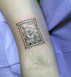 a stamp with a flower on the arm