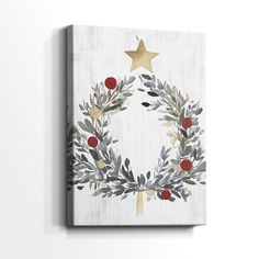 a white canvas with a christmas wreath painted on the front and gold stars above it