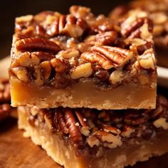 two pieces of pecan bars stacked on top of each other