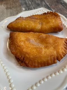 two pastries are sitting on a white plate