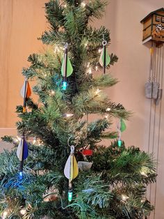 a small christmas tree with ornaments on it