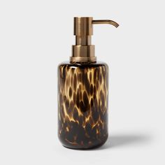 an animal print soap dispenser on a white background