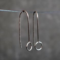 Minimalist silver wire earrings, dainty and delicate.  These geometric threaders are super lightweight and very comfortable to wear. You'll forget that you have them on. They look awesome for any occasion, discrete and simple but unique and elegant.  The total drop length measures about 1 3/16 inches (30mm). The idea behind this design was to create a pair of earrings with an elegant and simple look easy to match with any outfit. Choose between solid silver, 14k rose gold filled brass or 14k yellow gold filled brass in the drop down box. The wire is hardened, which make the earrings more resistant against deforming. You will receive these earrings in box ready to give as gift. For more unique jewelry: www.etsy.com/shop/BGLASSbcn Follow me on Instagram: @bgalssbcn Thank you for visiting my Simple Wire Earrings Antique, Cheap Dainty Earrings With Ear Wire, Cheap Silver Minimalist Linear Earrings, Affordable Minimalist Sterling Silver Earrings, Affordable Minimalist Wrap Earrings, Minimalist Hypoallergenic Wrap Earrings, Affordable Hypoallergenic Minimalist Wrap Earrings, Drop Earrings Simple Short Silver, Cheap Minimalist Silver Jewelry