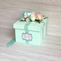 a small green box with some flowers in it