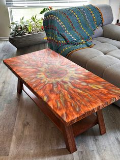 a coffee table sitting on top of a hard wood floor next to a gray couch