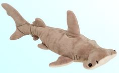 a stuffed shark is laying down on the floor