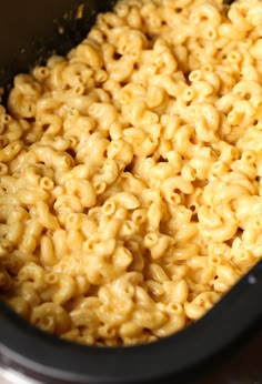 macaroni and cheese is being cooked in the crock pot