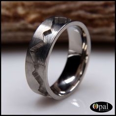 a silver ring with an arrow design on it