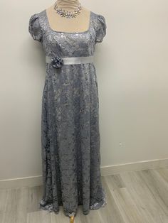 Beautiful gray/silver lace with sequins dress perfect for those tea parties or regency era parties this dress is made lace polyester and gray lining polyester.Please note it takes me 5-8 business days to produce and ship your dress after order is placed . THERE IS NO RETURNS OR EXCHANGES ACCEPTED  PLEASE BE SURE TO CHECK THE MEASUREMENTS ON THE BOTTOM OF THE DESCRIPTION. If for any reason the measurements don't  match with yours be sure to provide to me at the time of order. PLEASE NOTE COLOR MAY BE A LITTLE DIFFERENT ONCE YOU SEE IT, If measurements are not provided at the time of purchase we will send the dress with the measurements provided here on the listing PLEASE ADVISE OF THAT SMALL / BUST / Length                  34-36    44 MED   /    38-40 46 LARGE /. 40-42/ 48  PLEASE NOTE THE Silver Lace Dress For Prom, Gray Lace Evening Dress, Silver Fitted Lace Dresses, Gray Lace Dress For Formal Occasions, Silver Lace Formal Dress, Elegant Silver Lace Dress, Silver Lace Evening Dress, Regency Style Lace Formal Dress, Bridgerton Inspired Dress