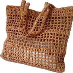 a brown crocheted bag is shown on a white background