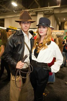 a man and woman are dressed up in costumes at an event together, posing for the camera