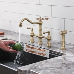 a person is washing their hands under a faucet in a kitchen sink with a sign that says stream mode column water