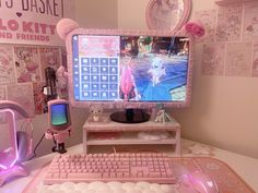 a desktop computer sitting on top of a desk next to a pink keyboard and mouse