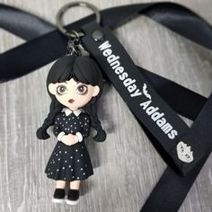 a keychain with a doll on it and a lanyard attached to it