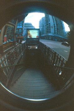 a bus traveling down a street next to tall buildings