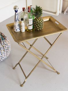 a tray with pineapples and bottles on it