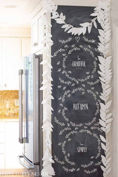 a chalkboard with white paper leaves on it and the words grateful written in black