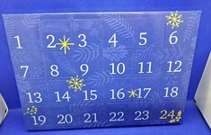 a blue and white calendar sitting on top of a blue chair with snowflakes