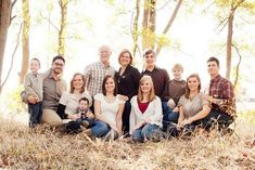 a family poses for a photo in the woods