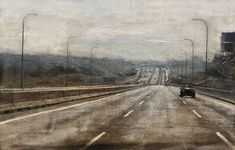 an old photo of a highway with cars driving down it